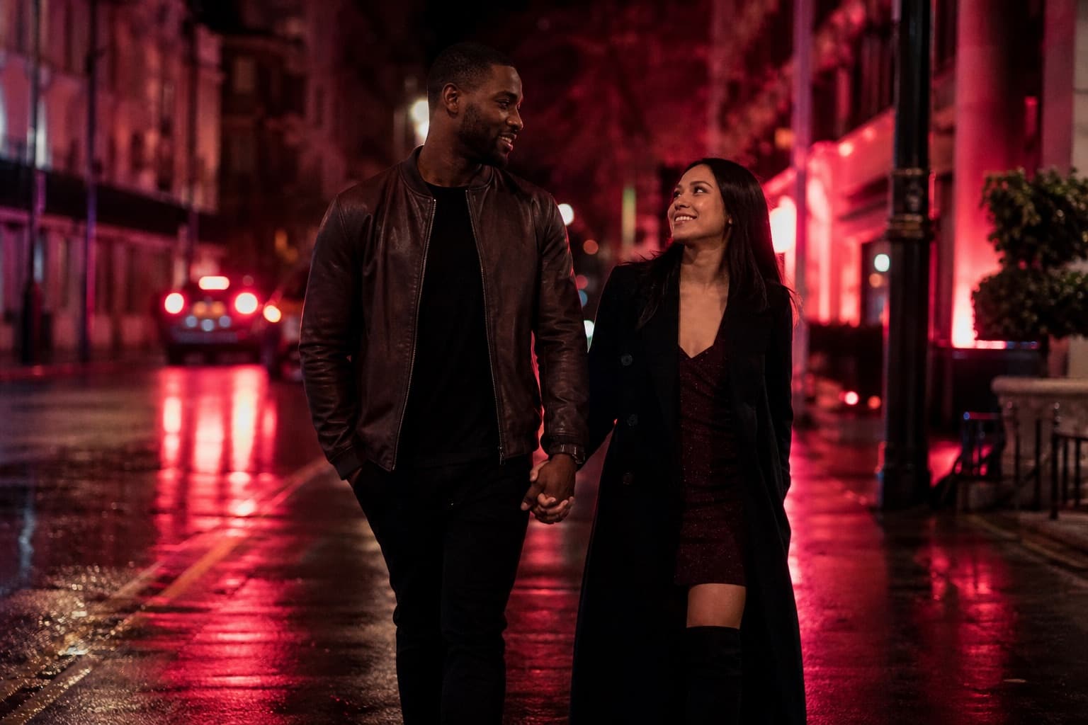 Couple walking together on a vibrant city street at night